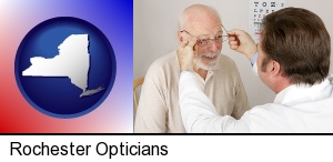 an optician fitting eyeglasses on an elderly patient in Rochester, NY