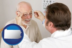 pennsylvania map icon and an optician fitting eyeglasses on an elderly patient