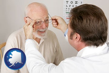 an optician fitting eyeglasses on an elderly patient - with Alaska icon