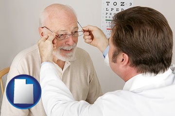 an optician fitting eyeglasses on an elderly patient - with Utah icon